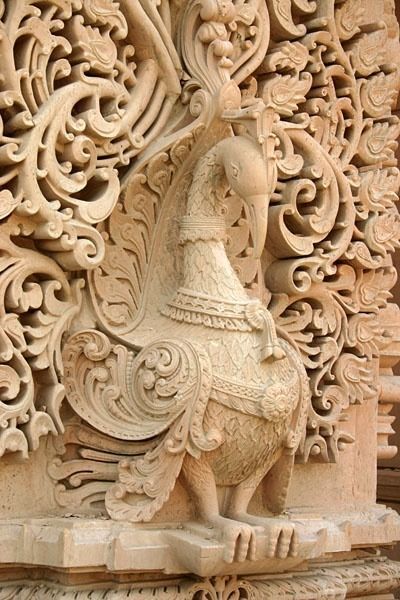 Ornate sandstone peacock sculpture carved with classical motifs