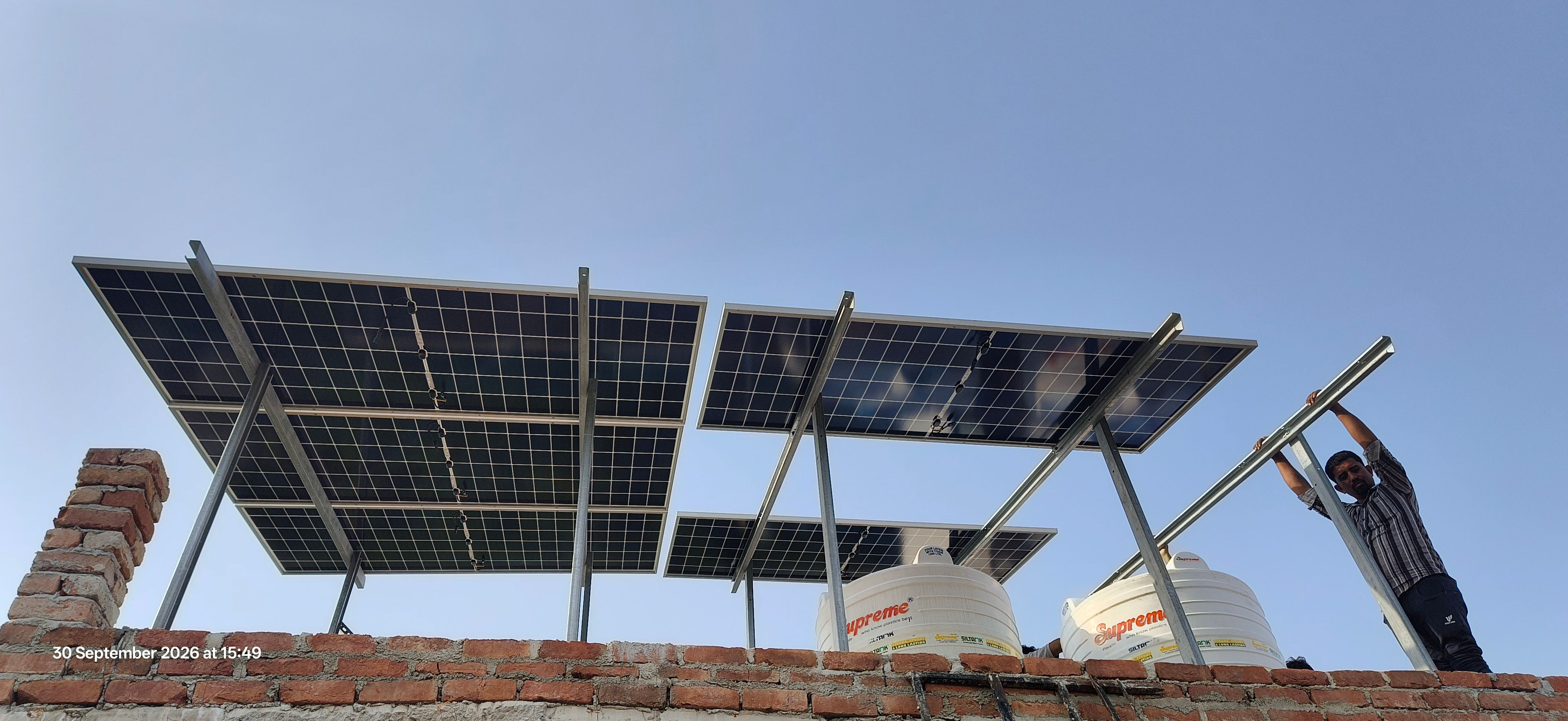 Elevated rooftop solar panel structure installation over residential terrace in Greater Noida
